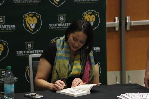 Talia Lakshmi Kolluri, author of “What we Fed to the Manticore,” signing attendees’ books at a Common Read event.