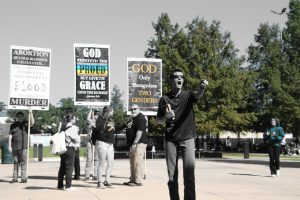 A Pentecostal preacher from Consuming Fire Fellowship bellows out a sermon to SLU passersby.