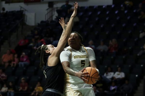 Senior guard Taylor Bell battles in the paint against UNO.