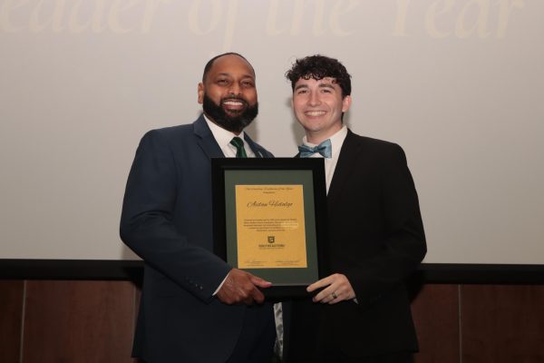 Dr. Eric Summers, vice president for student affairs, presents freshman health systems management major Aidan Hidalgo with the Outstanding Freshman of the Year award at the 2024 DSA Awards Convocation. 