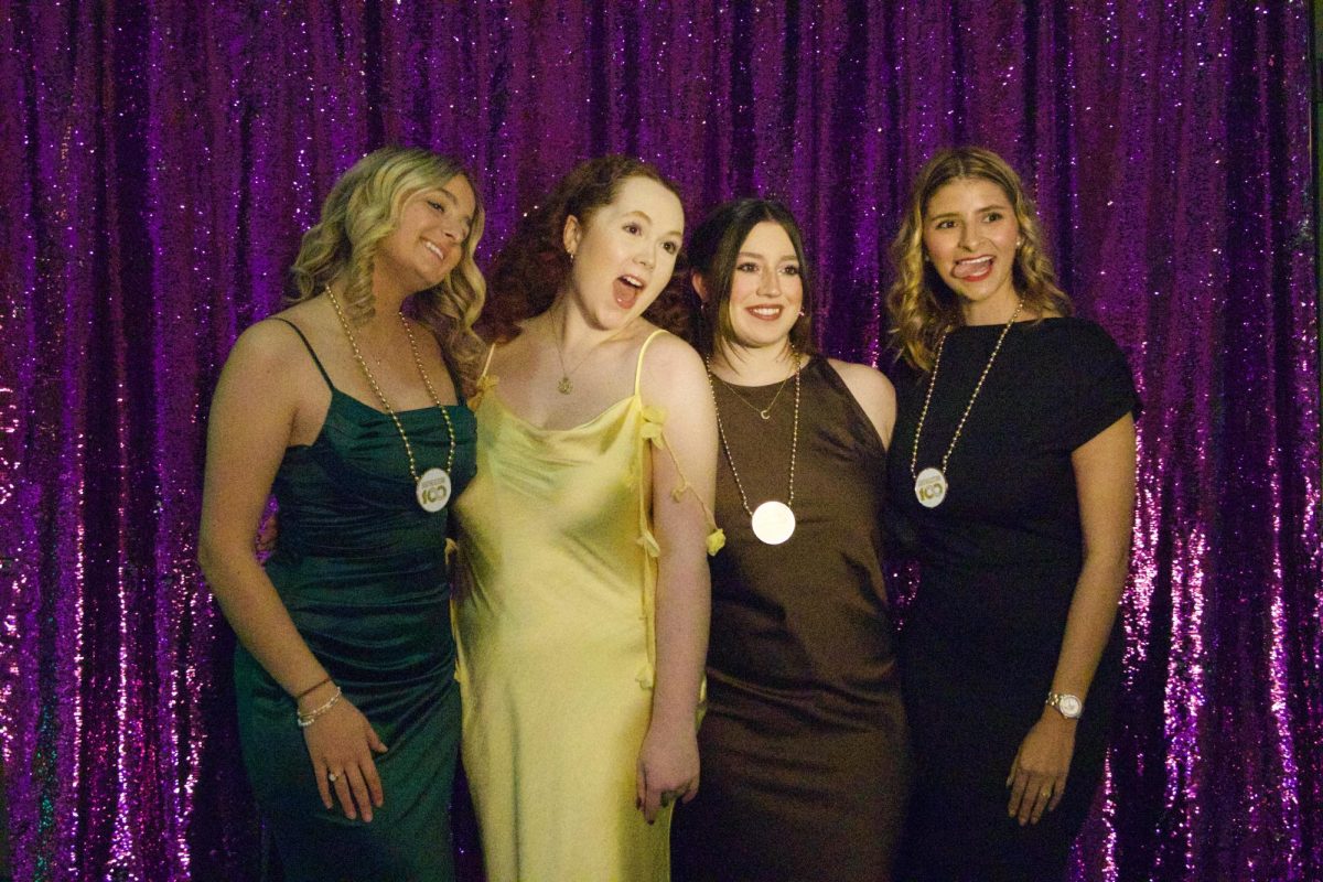 A group of students pose for a photo, enjoying their time at the ball. 