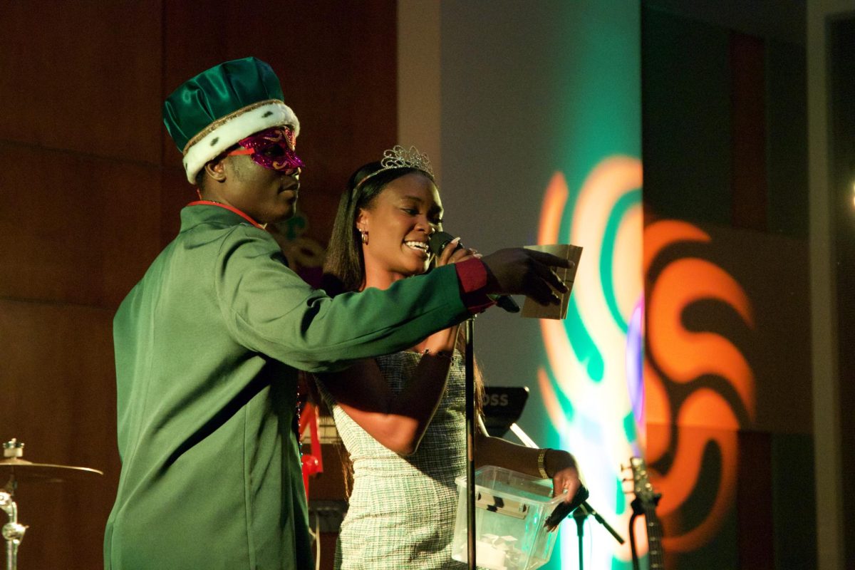 Lucky Ameh and Anyah Matthews address the crowd at the Mardi Gras Centennial Ball.