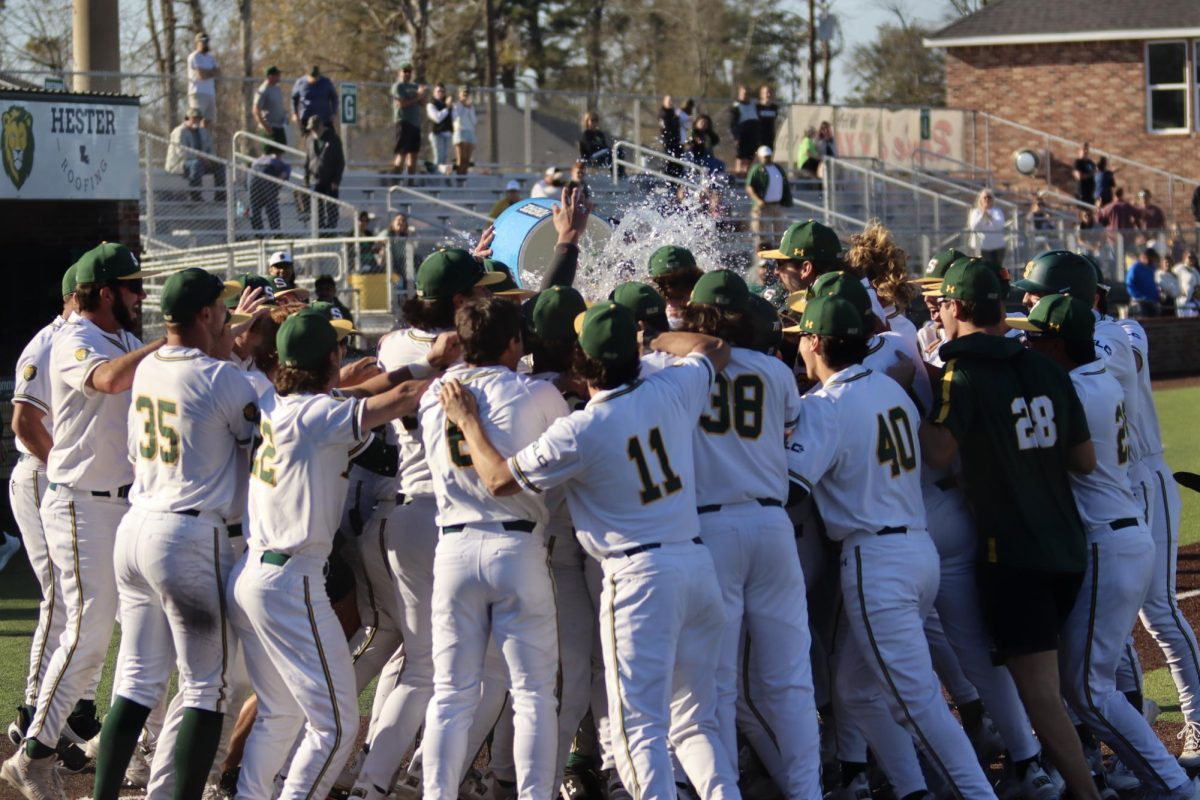 Conner O'Neal celebrated with his teammates at home plate after the walk-off home run against Northwestern.