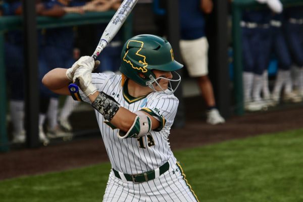 Maria Detillier, a junior infielder, eyes the pitcher and prepares to swing.