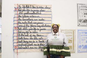 Raynia Johnson and her fiber art poem Outside In at the juried student exhibition.