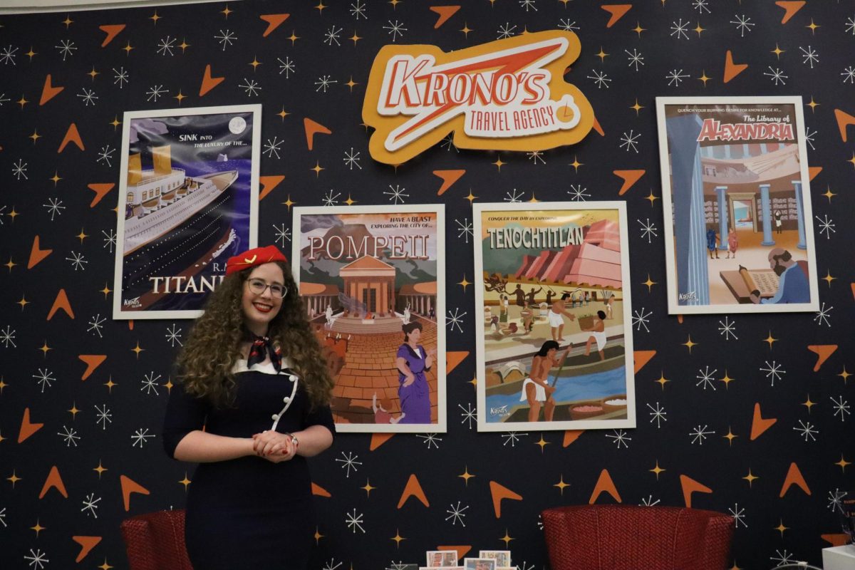 Senior graphic design major Ashton Persick presents her art project, "Krono's Travel Agency," at the Senior Art Exhibition.