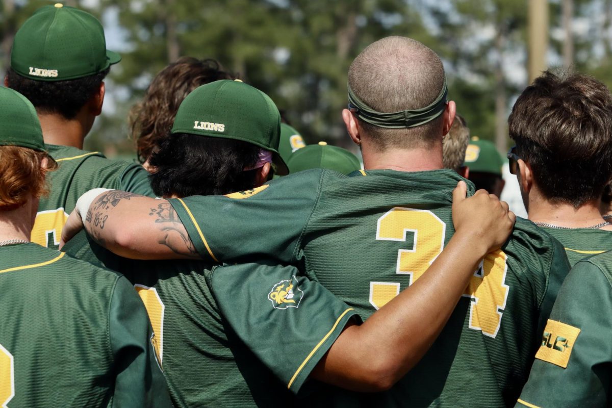Senior catcher Conner O'Neal wrapped arms with his teammate in the post-game huddle after they defeated McNeese.