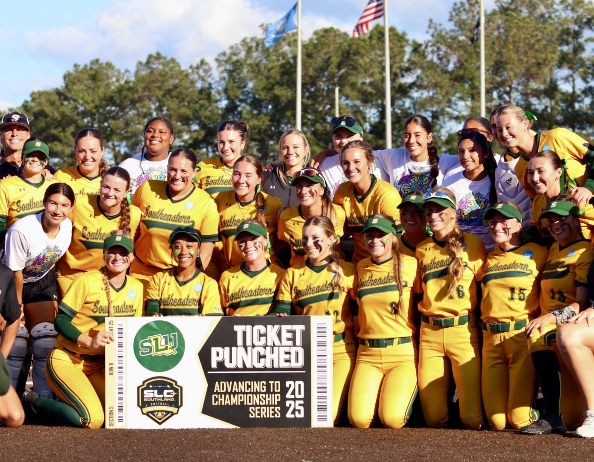 The Lady Lions gathered on the mound to show their ticket to SLC championship