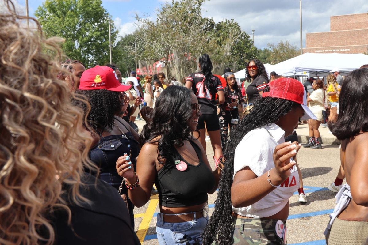 Members of Delta Sigma Theta Sorority, Inc., stroll during the 2025 Homecoming tailgate.