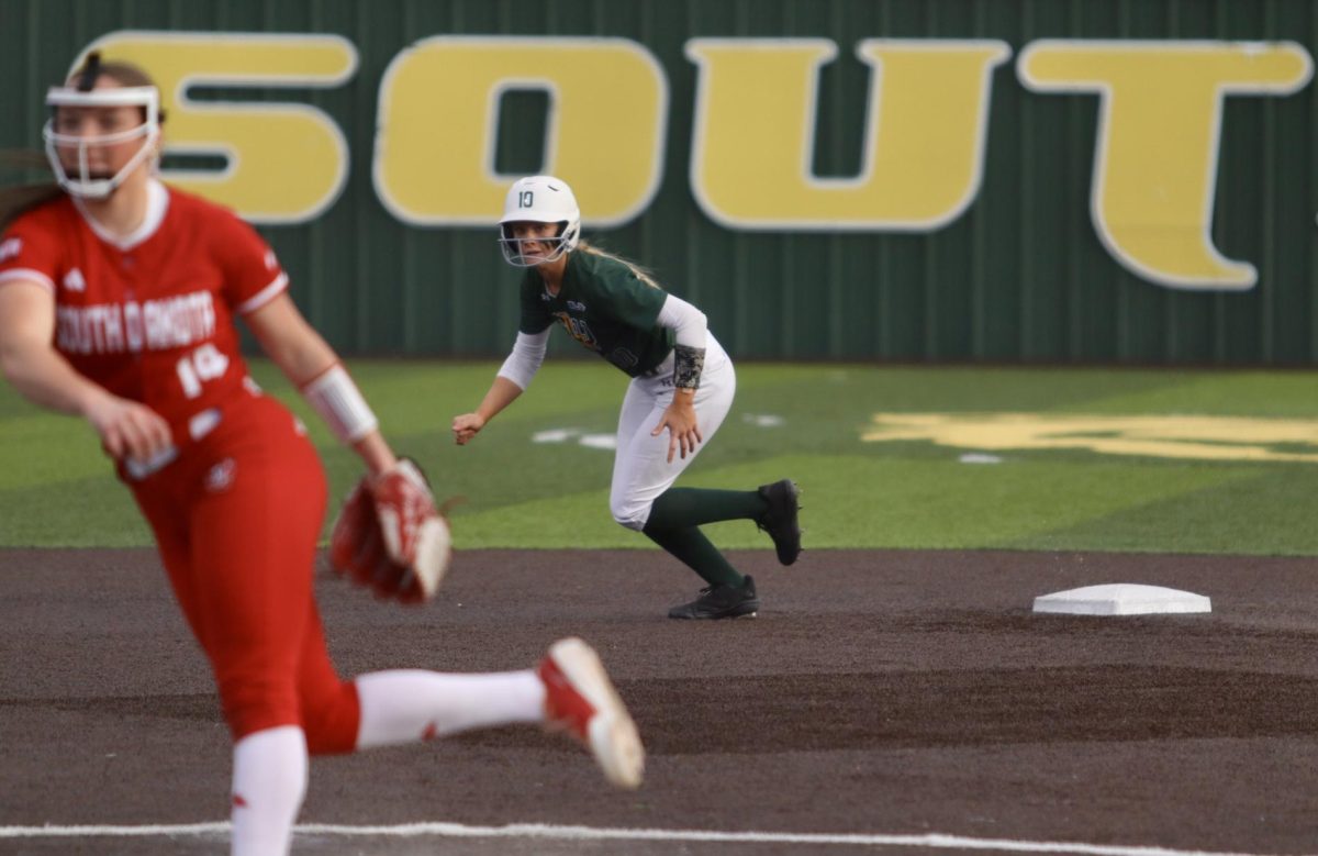 Southeastern player steals a base after the pitcher throws the ball.