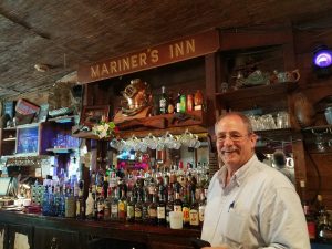 a man posed at a bar
