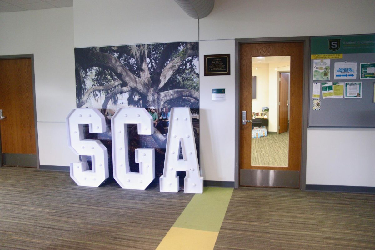 A set of large letters spelling "SGA" outside an office.