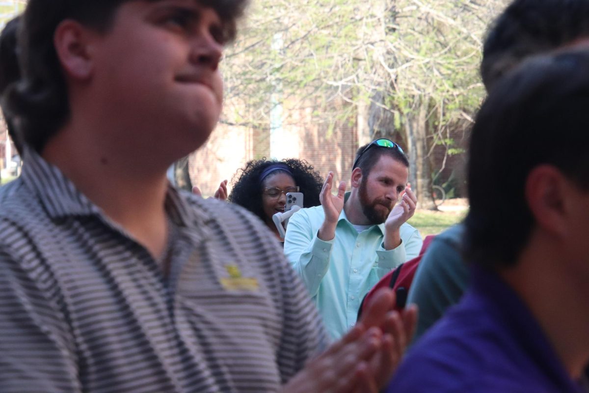 People standing and clapping.