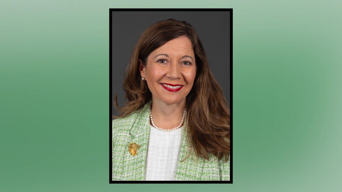 a woman with a green jacket posed with a green background