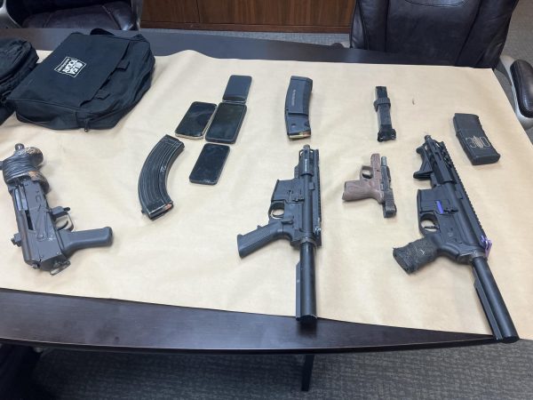 Guns on a wooden table.